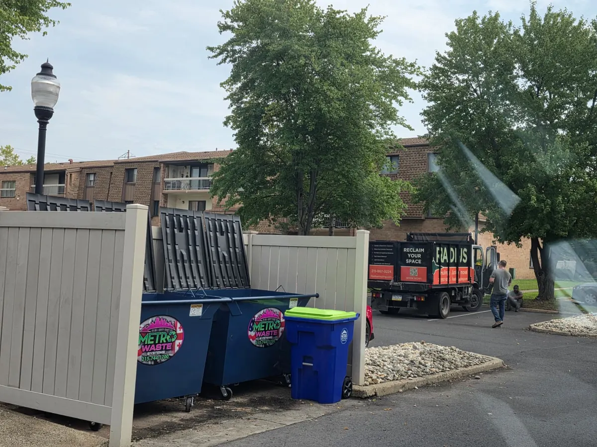Commercial waste collection truck servicing a business