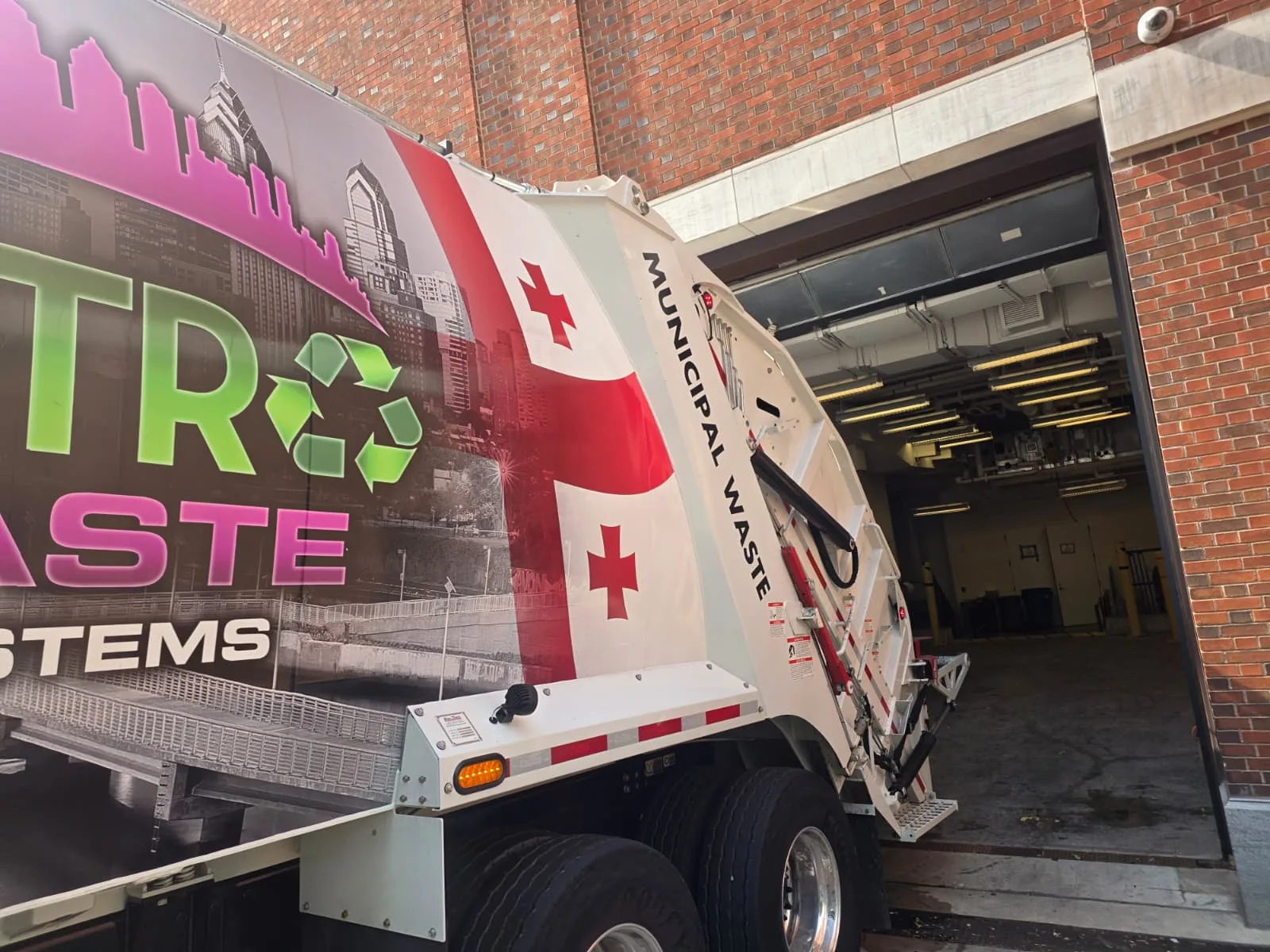 Front-load commercial waste truck servicing a Philadelphia business