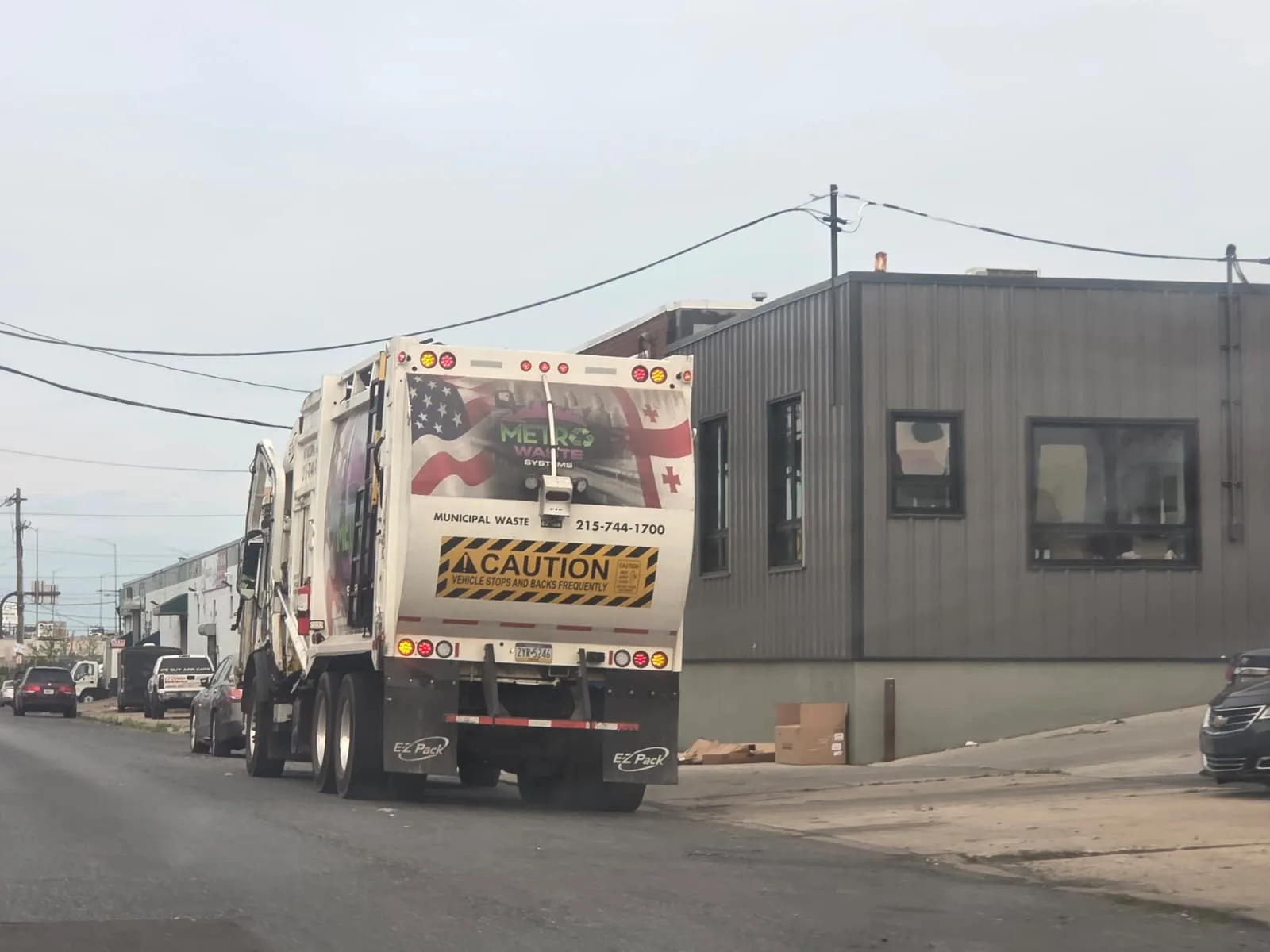 Rear-load commercial waste collection truck from Metro Waste Solutions on a Philadelphia metro route — photo 4
