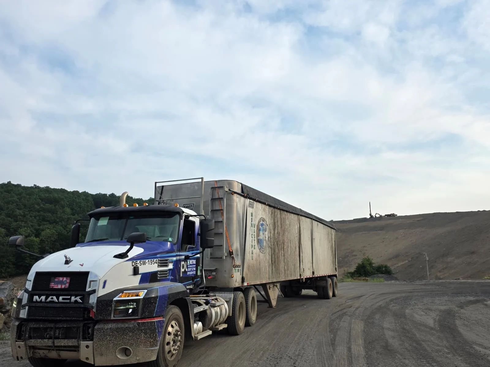 Heavy-haul tractor moving waste containers